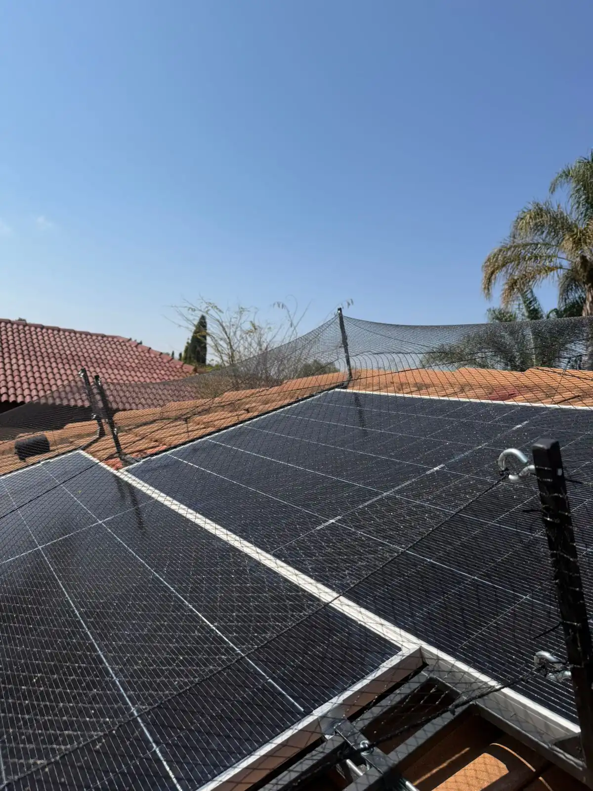 Golf ball netting tensioned over solar panels, Pretoria East golf estate